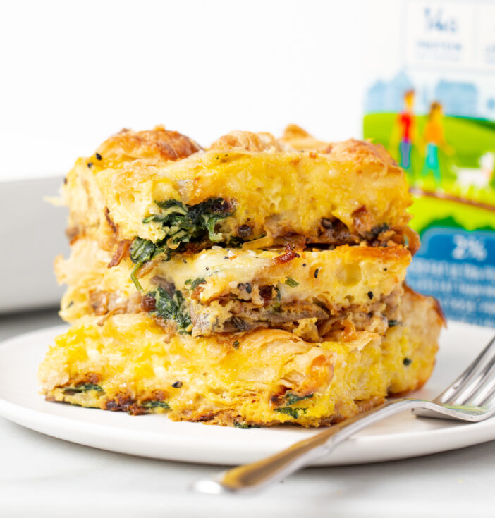 An egg casserole on a white plate and a fork